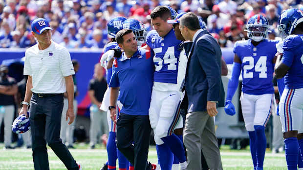 New York Giants inside linebacker Blake Martinez (54) is helped off the field in the first half at MetLife Stadium on Sunday, Sept. 26, 2021, in East Rutherford.